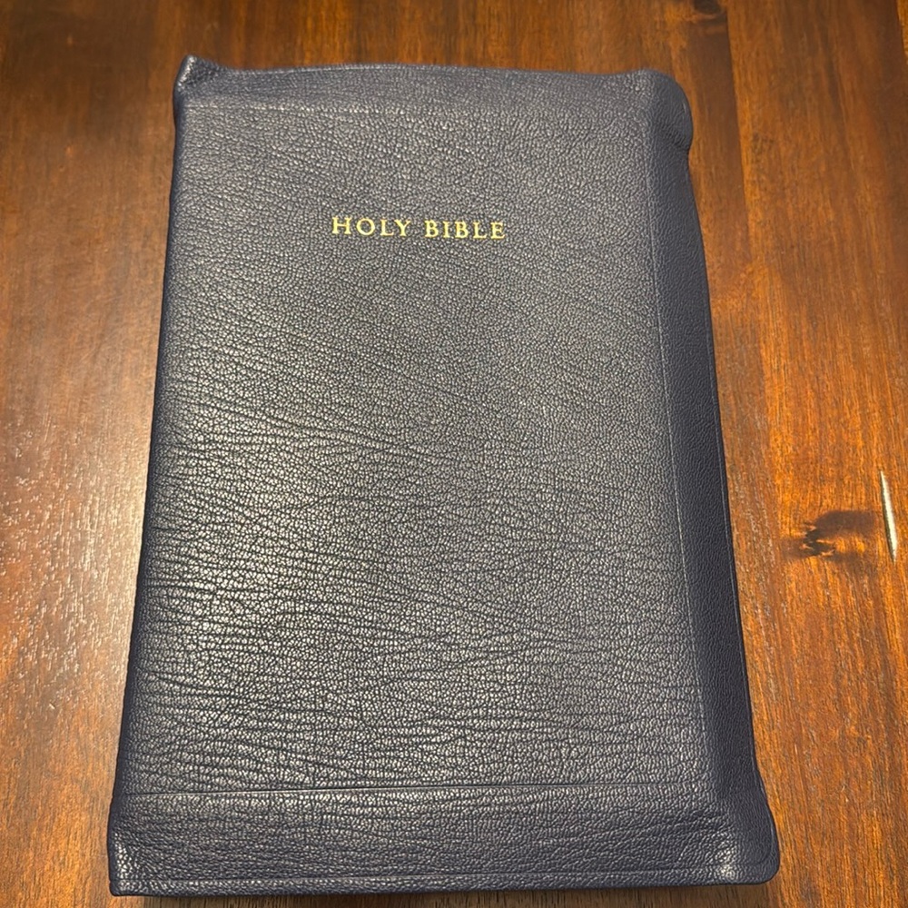 Allan 63 longprimer in navy blue with speckled edges.